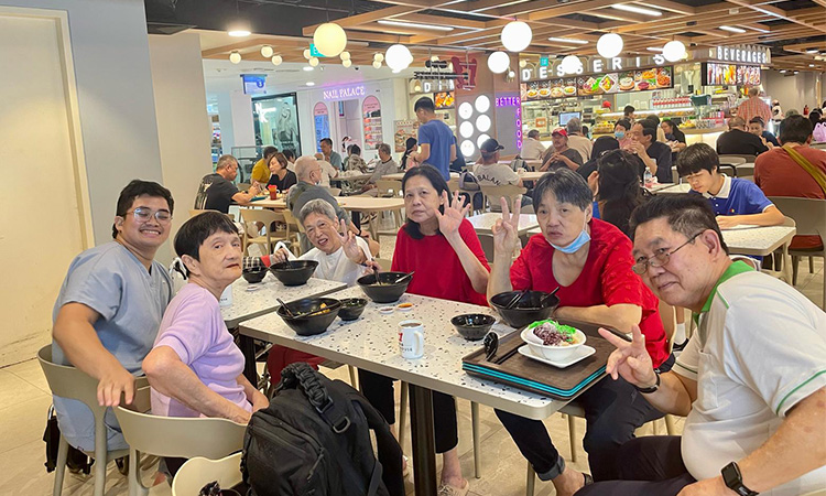 Nursing home residents enjoying a group outing for food.