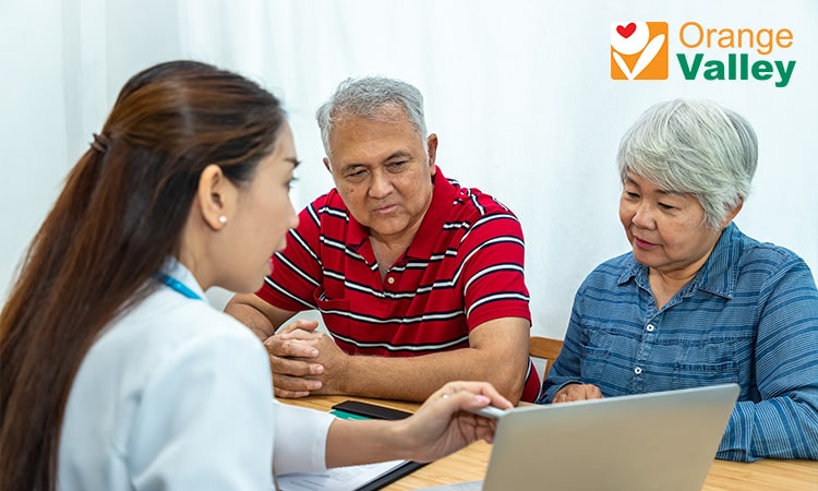 Nurse consulting elderly patient and family member