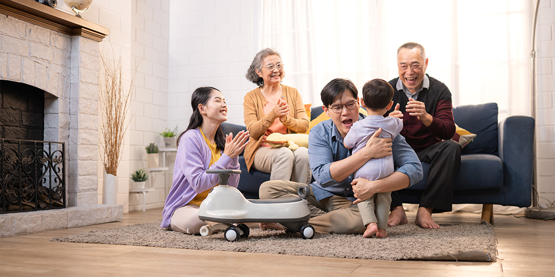 Multi-generational family gathered in living room