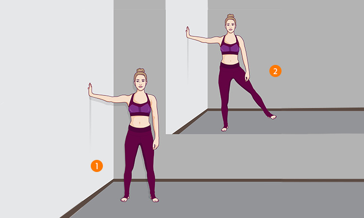 Woman performing standing side leg raise exercise.
