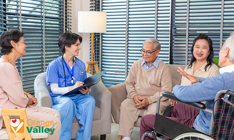 Nurse leading a wellness discussion for nursing home residents.
