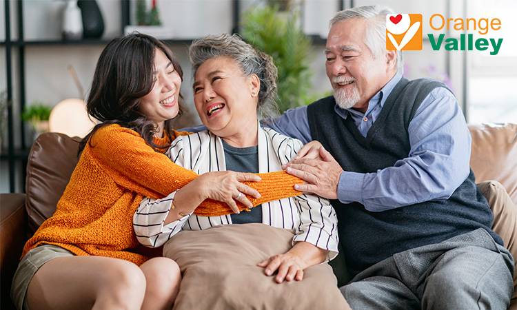 Happy family sharing a laugh with an elderly relative.